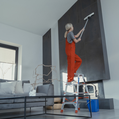 woman cleans wall